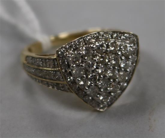 A modern 9ct gold and pave set diamond dress ring with diamond set shoulders, size O.